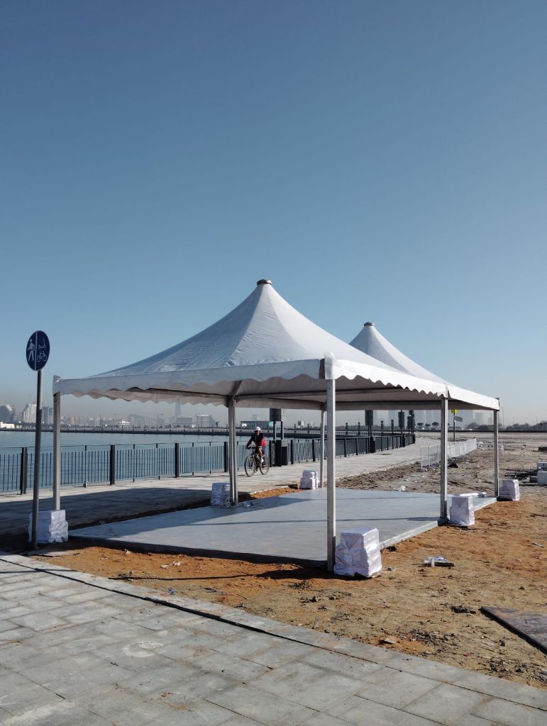 Pagoda shade tents installed on a waterfront promenade in the UAE by Mahraj Industries